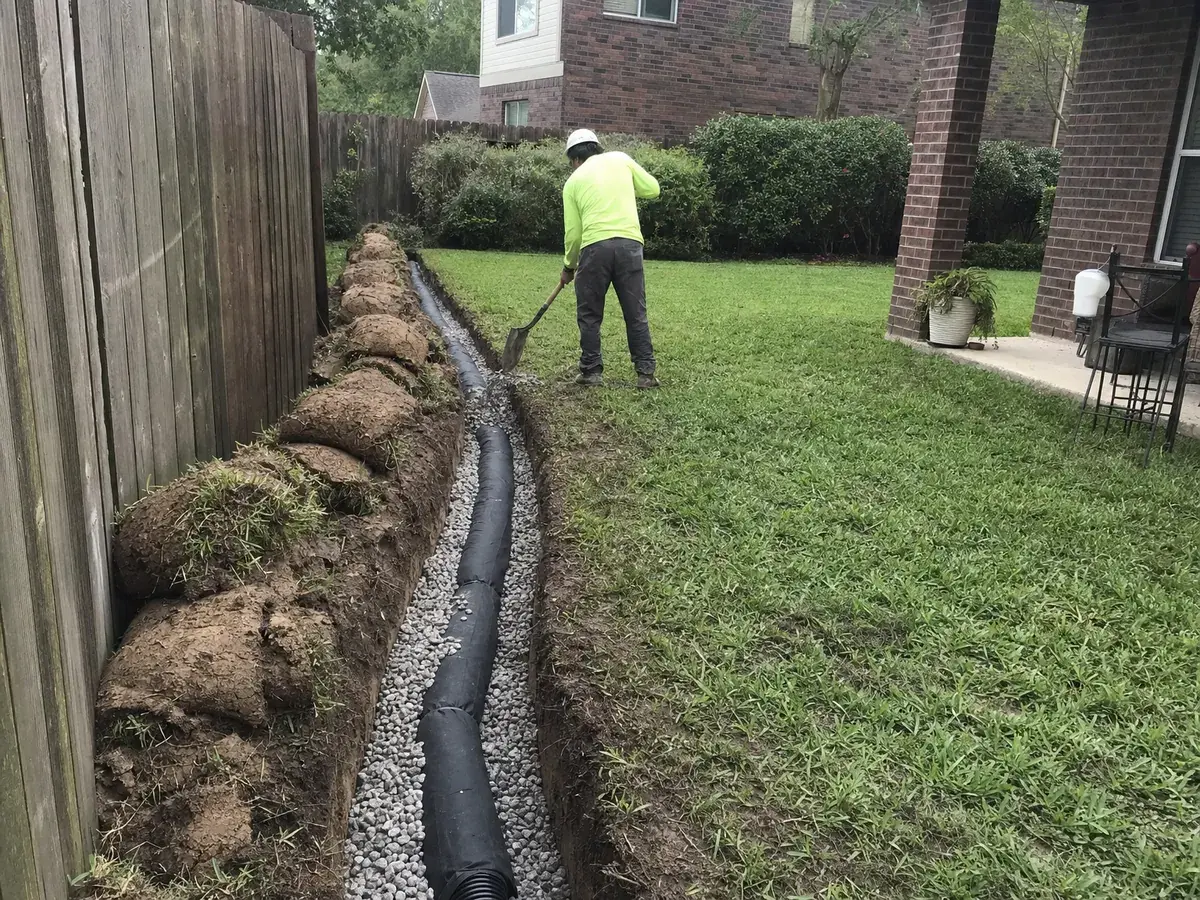 French drain trench with perforated pipe, filter fabric and washed gravel